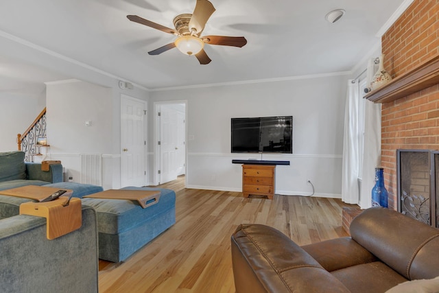 1186 Peebles Dr, Smyrna, TN 37167 - living area featuring a ceiling fan, light wood-style flooring, ornamental molding, stairway, and a brick fireplace