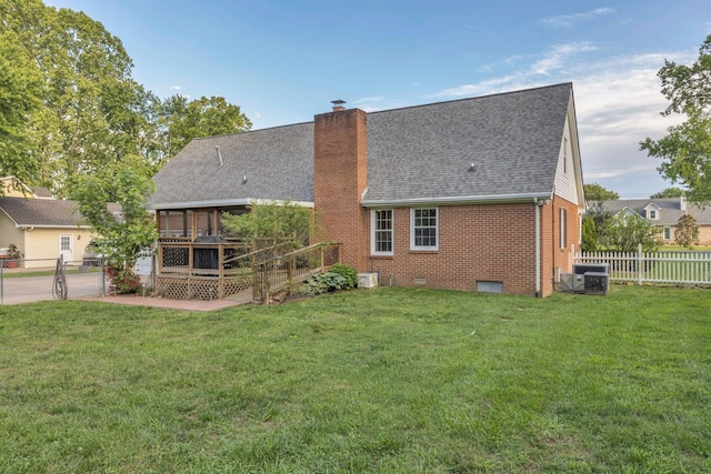 1186 Peebles Dr, Smyrna, TN 37167 - back of property with brick siding, a deck, roof with shingles, a chimney, and central AC unit