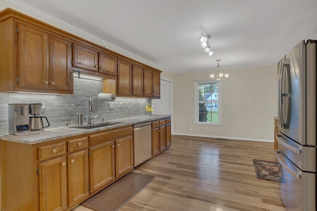 1186 Peebles Dr, Smyrna, TN 37167 - kitchen with stainless steel appliances, a sink, a chandelier, decorative backsplash, and baseboards