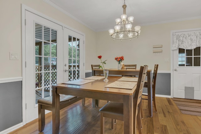 1186 Peebles Dr, Smyrna, TN 37167 - dining room featuring a chandelier, wood finished floors, ornamental molding, baseboards, and french doors