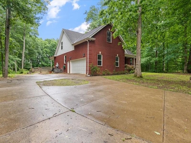 3904 Rowland Rd, Murfreesboro, TN 37128 - view of side of home featuring concrete driveway, brick siding, and a garage