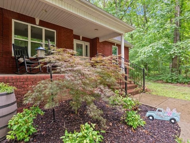 3904 Rowland Rd, Murfreesboro, TN 37128 - view of side of home with brick siding, covered porch, and stairway