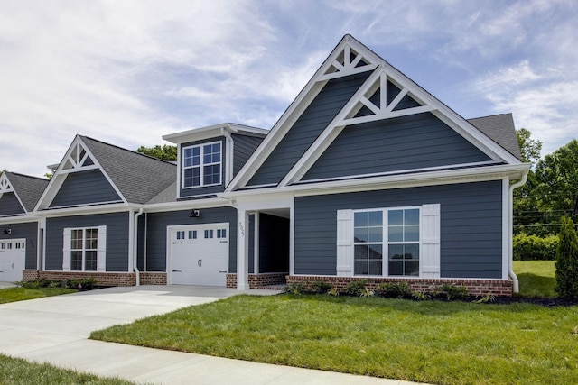 2027 Rylee Way, Greenbrier, TN 37073 - craftsman-style home featuring a front lawn, driveway, brick siding, an attached garage, and a porch