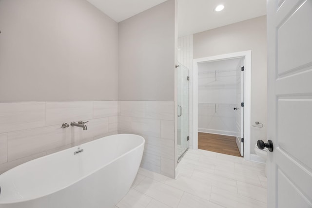 2060 Rylee Way Unit 54, Greenbrier, TN 37073 - full bathroom featuring a shower stall, a walk in closet, a soaking tub, and recessed lighting