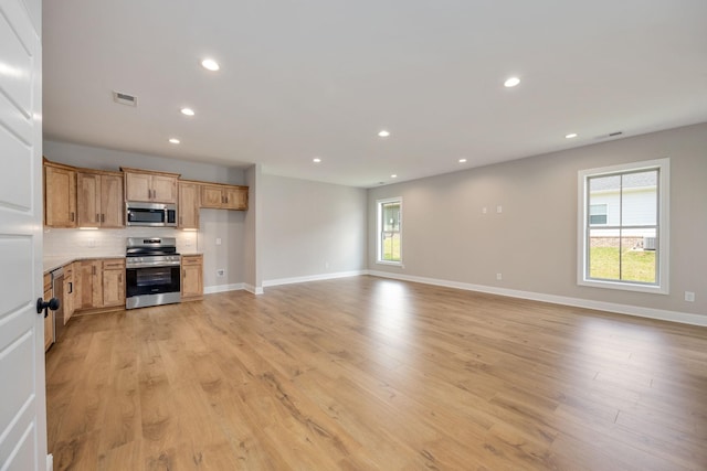 2060 Rylee Way Unit 54, Greenbrier, TN 37073 - unfurnished living room with baseboards, light wood finished floors, and recessed lighting