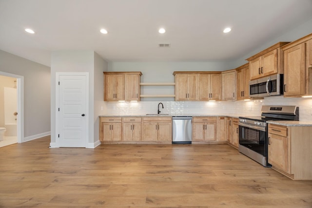 2060 Rylee Way Unit 54, Greenbrier, TN 37073 - kitchen featuring stainless steel appliances, light brown cabinets, a sink, open shelves, and backsplash