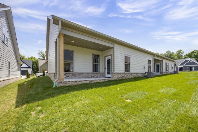 2060 Rylee Way Unit 54, Greenbrier, TN 37073 - rear view of property featuring cooling unit, a lawn, and brick siding