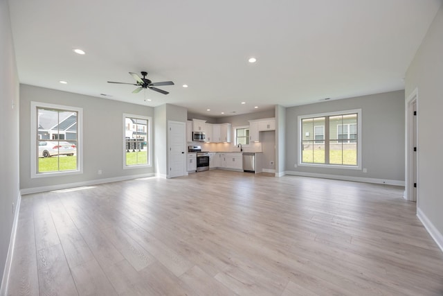 2050 Rylee Way, Greenbrier, TN 37073 - unfurnished living room featuring light wood finished floors, baseboards, ceiling fan, and recessed lighting