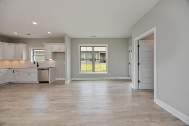 2050 Rylee Way, Greenbrier, TN 37073 - kitchen featuring stainless steel dishwasher, white cabinets, backsplash, recessed lighting, and light wood-style floors