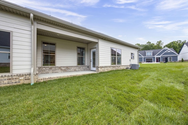 2050 Rylee Way, Greenbrier, TN 37073 - back of property with brick siding, a lawn, and central AC unit