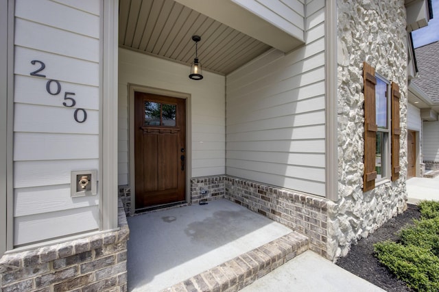 2050 Rylee Way, Greenbrier, TN 37073 - doorway to property with covered porch and stone siding