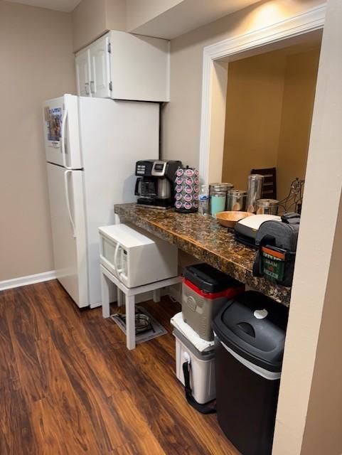 1280 Middle Tennessee Blvd Unit A8, Murfreesboro, TN 37130 - kitchen with dark wood-type flooring, white cabinetry, dark countertops, baseboards, and freestanding refrigerator