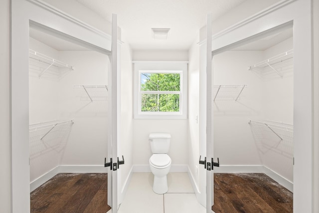 5706 Wilder Rd S, Grimsley, TN 38565 - bathroom featuring toilet, baseboards, and a walk in closet