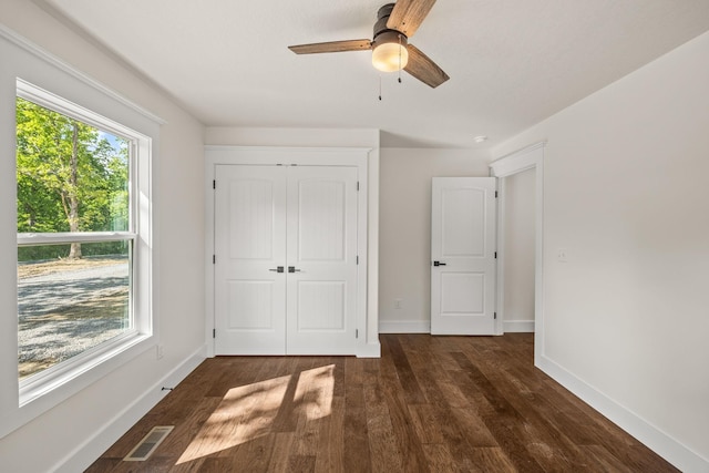 5706 Wilder Rd S, Grimsley, TN 38565 - unfurnished bedroom featuring dark wood-type flooring, baseboards, a closet, and a ceiling fan