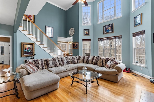 550 Tanya Dr, Whitwell, TN 37397 - living room with stairway, a ceiling fan, wood finished floors, a high ceiling, and crown molding