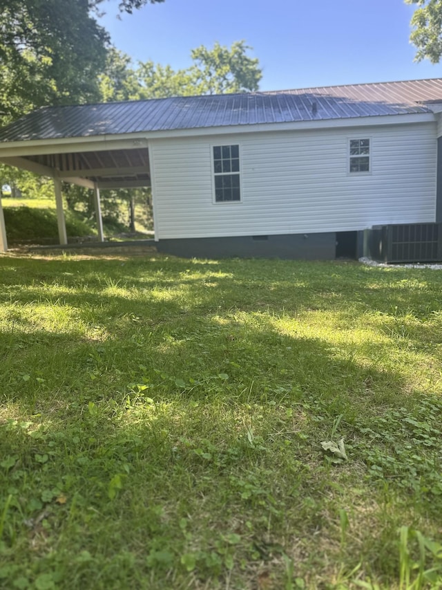 1207 Swanson Blvd, Fayetteville, TN 37334 - view of side of property with a lawn, metal roof, and central AC