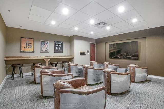carpeted cinema room with baseboards