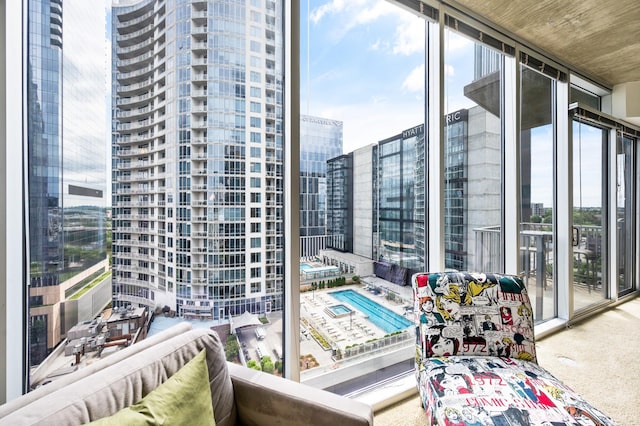 balcony featuring view of pool area and a city view