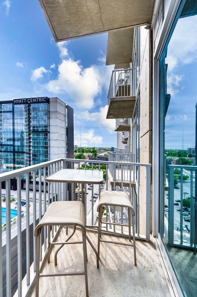 balcony featuring view of pool area