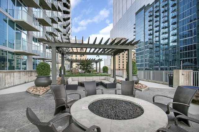 view of patio / terrace featuring a pergola and an outdoor living space with a fire pit
