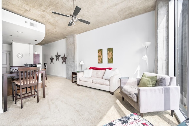 carpeted living room with a ceiling fan