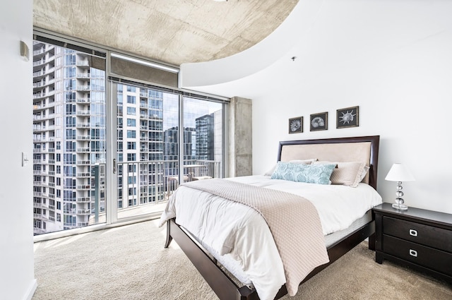 bedroom with multiple windows, a wall of windows, carpet floors, and access to outside
