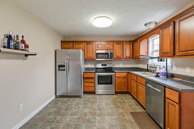 2405 Cason Ln, Lewisburg, TN 37091 - kitchen featuring appliances with stainless steel finishes, a sink, dark countertops, and brown cabinets