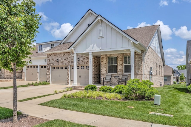 416 Golden Meadow Ln, Hendersonville, TN 37075 - view of front facade with board and batten siding, a porch, an attached garage, a front yard, and concrete driveway