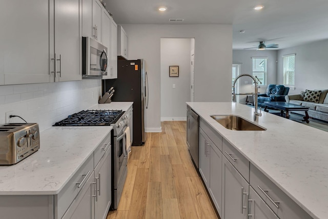 416 Golden Meadow Ln, Hendersonville, TN 37075 - kitchen featuring appliances with stainless steel finishes, a sink, gray cabinetry, recessed lighting, and tasteful backsplash