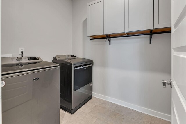 416 Golden Meadow Ln, Hendersonville, TN 37075 - washroom with cabinet space, washing machine and clothes dryer, baseboards, and light tile patterned floors
