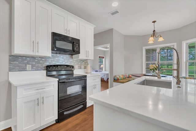 580 Laurel Ln, Murfreesboro, TN 37127 - kitchen featuring black appliances, light countertops, light wood-type flooring, and tasteful backsplash