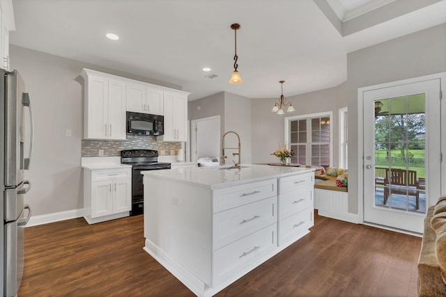 580 Laurel Ln, Murfreesboro, TN 37127 - kitchen featuring black appliances, a sink, dark wood-type flooring, light countertops, and decorative backsplash