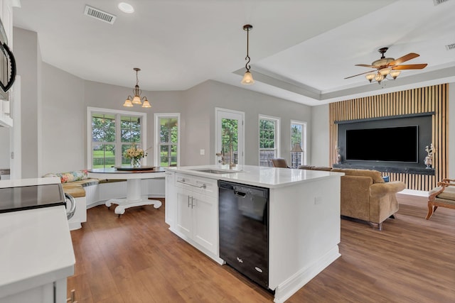 580 Laurel Ln, Murfreesboro, TN 37127 - kitchen with black appliances, white cabinets, wood finished floors, light countertops, and hanging light fixtures