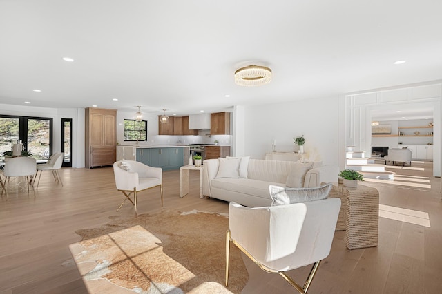 living area with light wood-style floors and recessed lighting
