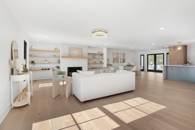 living area featuring light wood-style floors, a fireplace, and recessed lighting