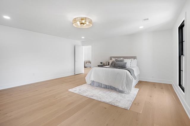 bedroom with light wood-type flooring, a chandelier, recessed lighting, and baseboards