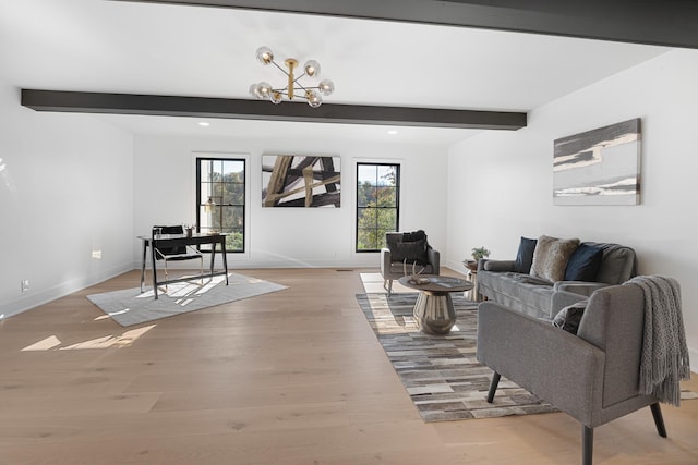 living room featuring beam ceiling, baseboards, a chandelier, and light wood finished floors