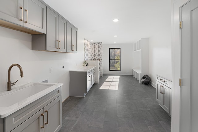 clothes washing area featuring cabinet space, electric dryer hookup, recessed lighting, and baseboards