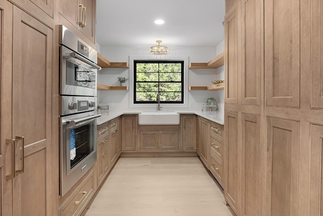 kitchen featuring open shelves, a sink, double oven, light wood finished floors, and recessed lighting