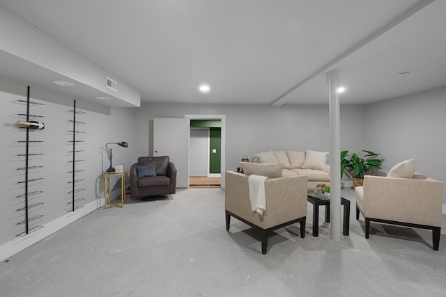 living room featuring finished concrete flooring and recessed lighting