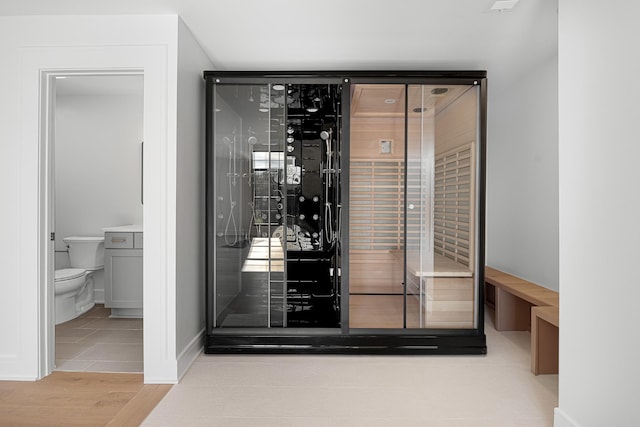 wine area featuring wood finished floors and baseboards