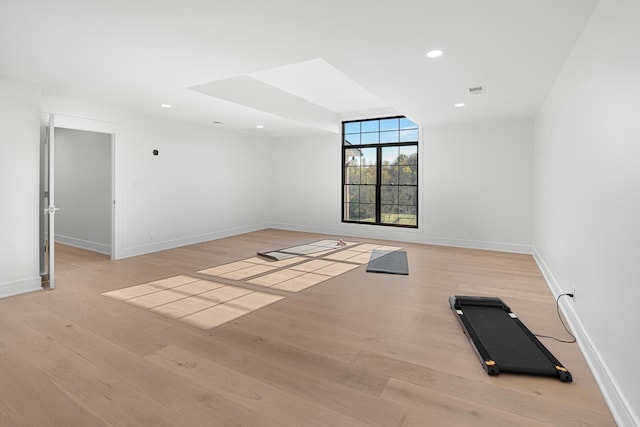 empty room with baseboards, light wood-style floors, and recessed lighting