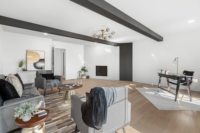 living area featuring beam ceiling, wood finished floors, recessed lighting, and baseboards