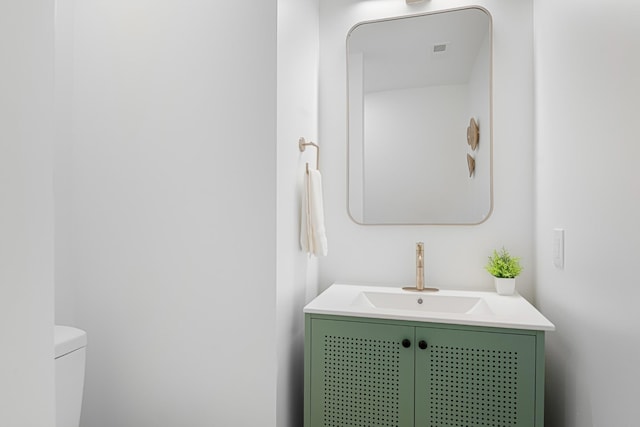 bathroom featuring toilet and vanity