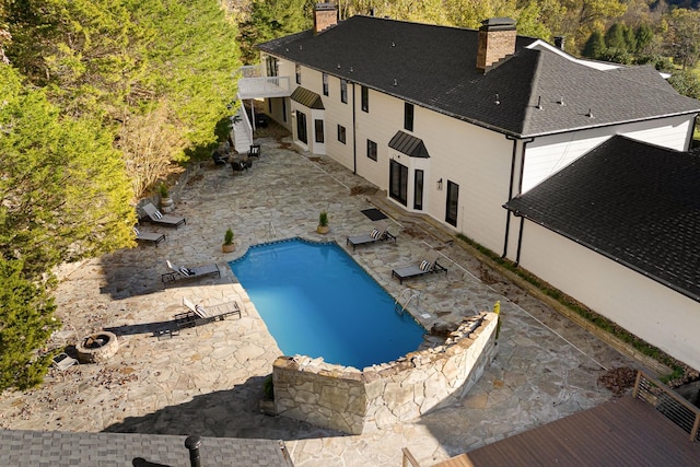 outdoor pool with a patio area