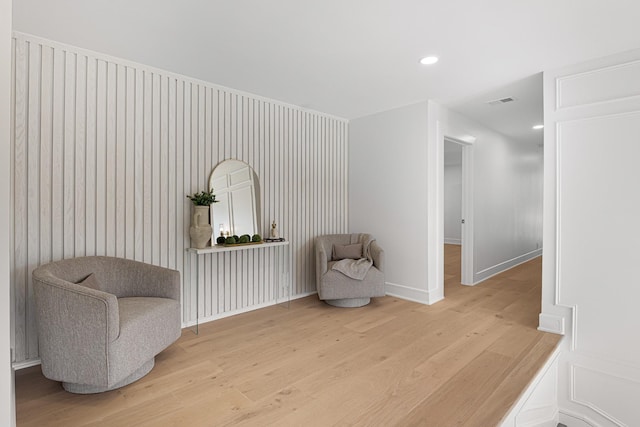 sitting room with light wood finished floors, baseboards, and recessed lighting