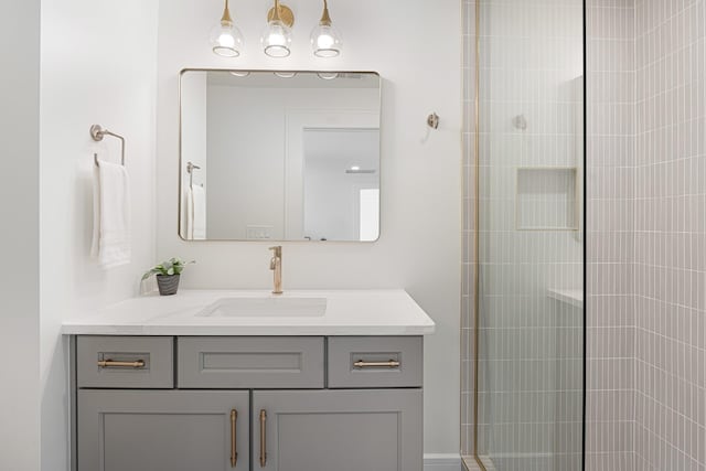 bathroom featuring vanity and tiled shower