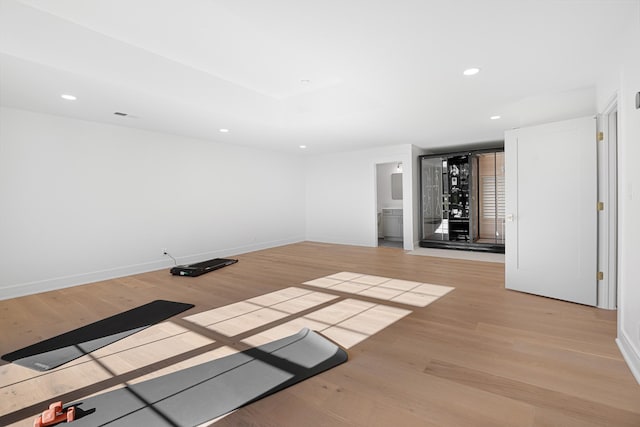 spare room with light wood-style floors, recessed lighting, and baseboards