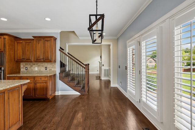 1769 Mayflower Dr, Columbia, TN 38401 - kitchen with brown cabinetry, crown molding, dark wood-style flooring, baseboards, and backsplash