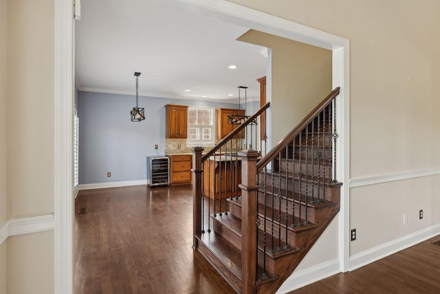 1769 Mayflower Dr, Columbia, TN 38401 - stairs with beverage cooler, wood finished floors, baseboards, ornamental molding, and recessed lighting